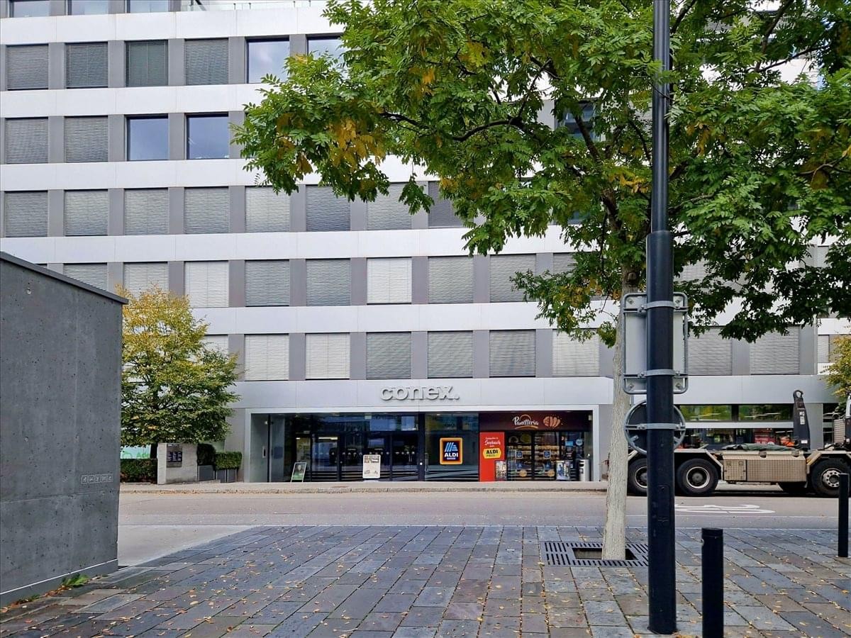 Exterior view of the office building at Schärenmoosstrasse 77 featuring a modern grey facade.