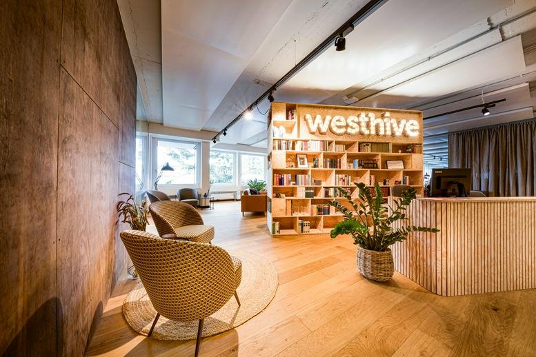 Reception area with warm lighting and wooden bookshelves.