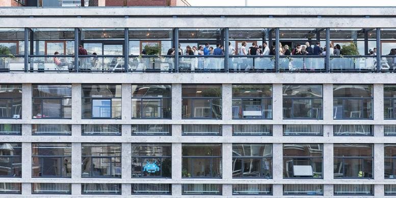 Exterior view of the TNW Spaces, Singel 542 building showing multiple floors and a rooftop terrace.
