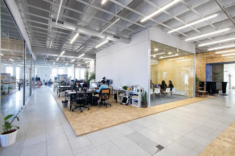 Spacious interior of the Sofia Center, Shipka Street 6 office with open-plan desks and glass meeting rooms.