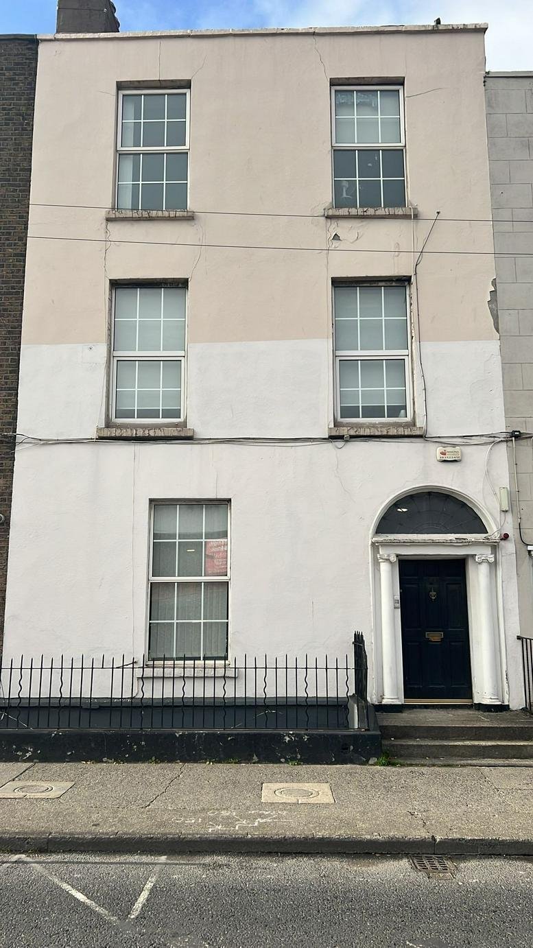 Exterior facade of Solomons House, 60 Amiens Street, Dublin, a three-story period building with a blue arched door.