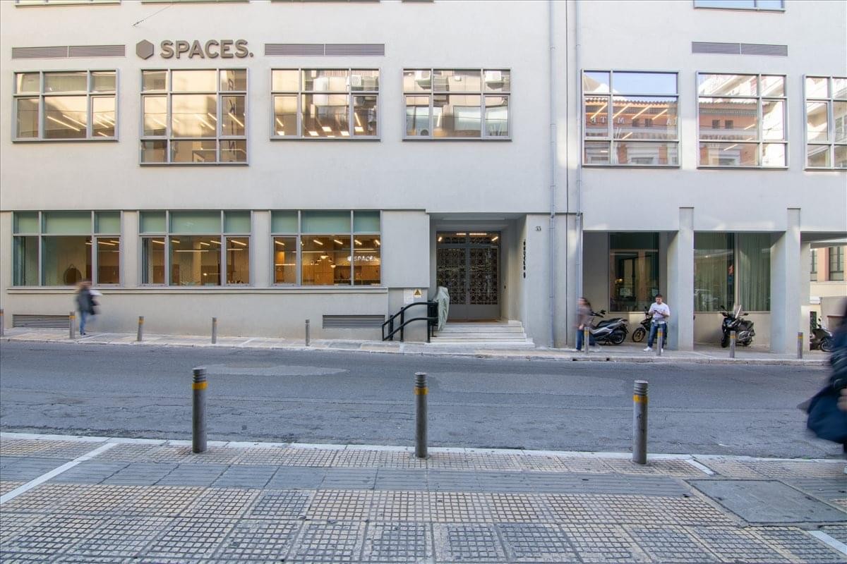 Exterior facade of the white Spaces building at Solonos 53 & Sina Str.