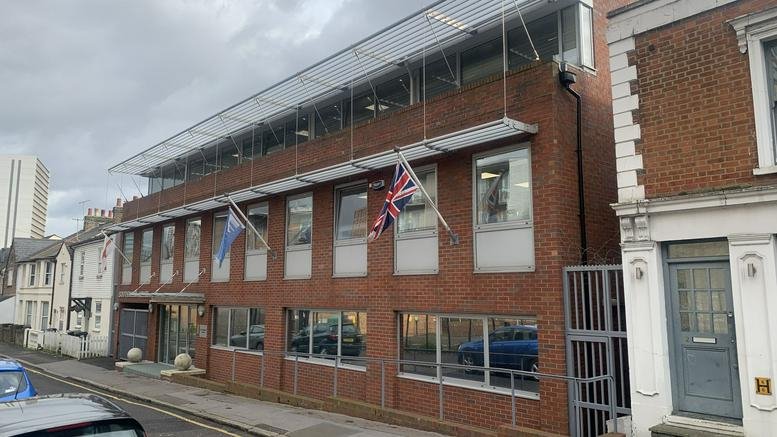 Exterior view of the brick facade and modern glass extension at Southbridge Place, Croydon.
