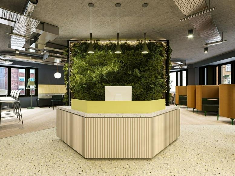 Modern reception area at Sovereign Gate, 18-20 Kew Road, London with a living green wall and light wood desk.