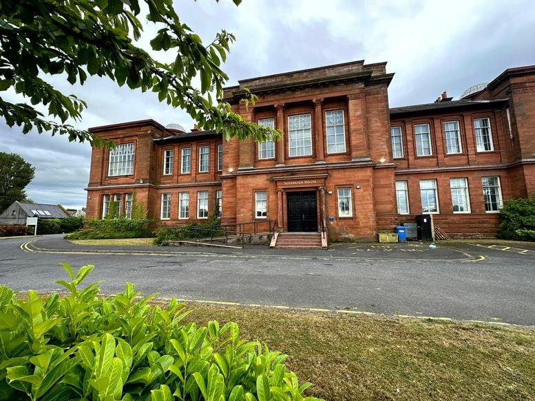 Exterior view of the red sandstone facade of Sovereign House, Academy Road, Irvine (United Kingdom).
