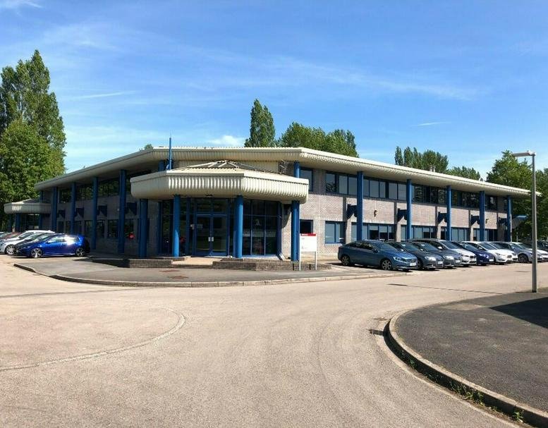 Exterior view of the low-rise St. Mellons Business Park, Fortran Road, Cardiff with parking area.