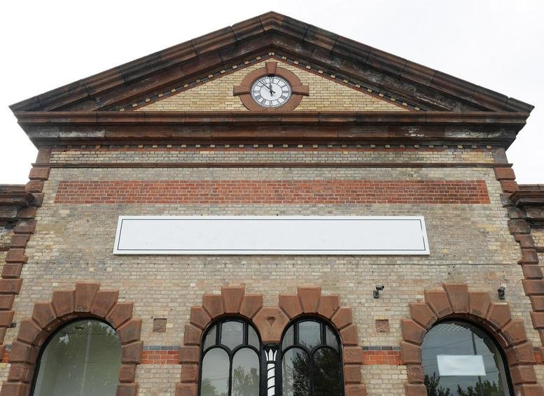 Exterior view of the historic brick and stone facade of Station House, Central Way, Warrington.