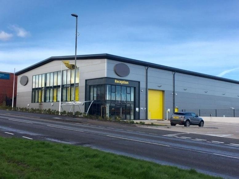 Exterior view of the modern gray and glass warehouse building at SureStore, Industrial Estate in Lichfield.