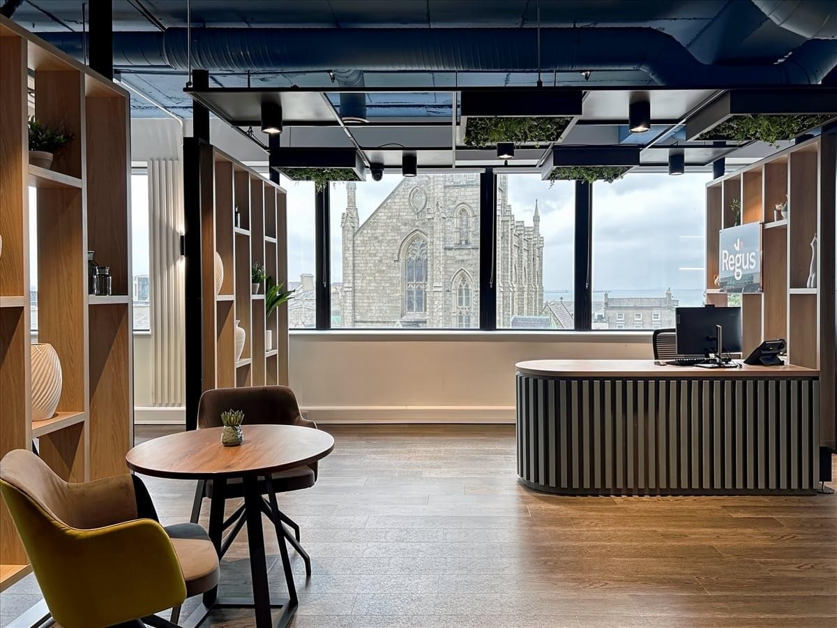 Temple House reception area featuring a fluted desk and views of a historic church.