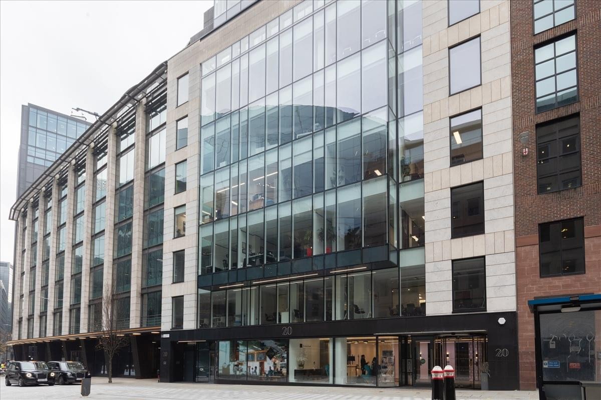 Exterior view of the contemporary glass and stone facade at The Clubhouse Holborn Circus, 20 Andrew Street.
