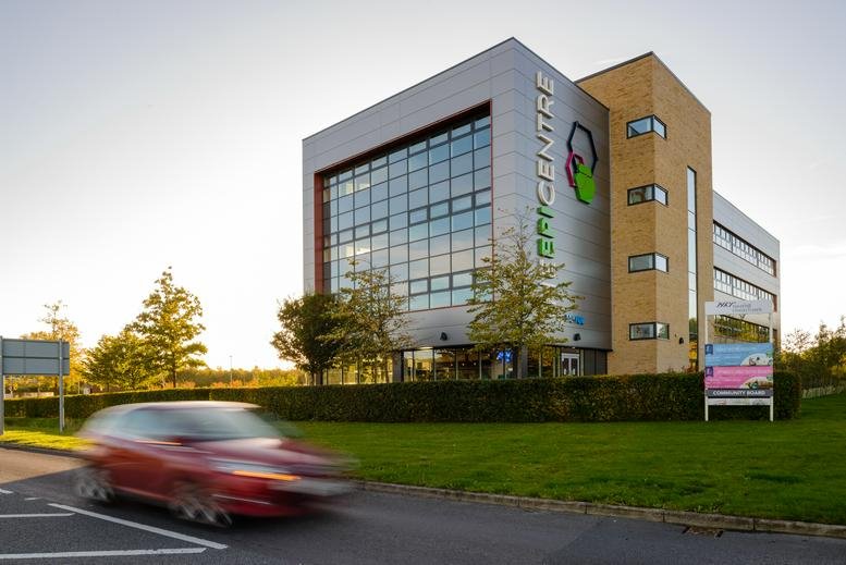 Wide view of the modern multi-story exterior of The Epicentre at sunset.