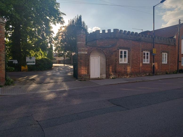 Exterior brick facade of The Gatehouse, 33, St Andrews Street South with decorative battlements.