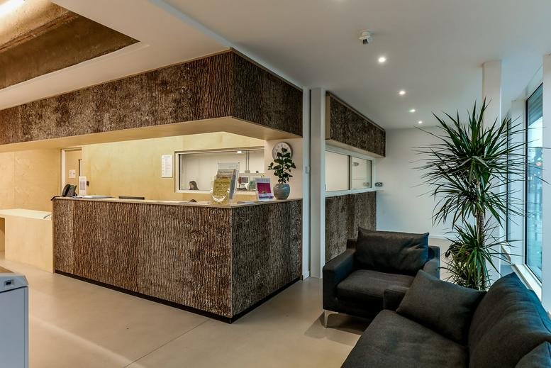 The Green House reception area with a textured cork-fronted desk and comfortable lounge seating.