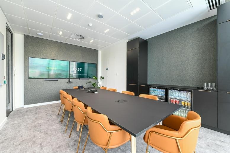Spacious meeting room at The Heights, Weybridge, Surrey with leather chairs and double screens.
