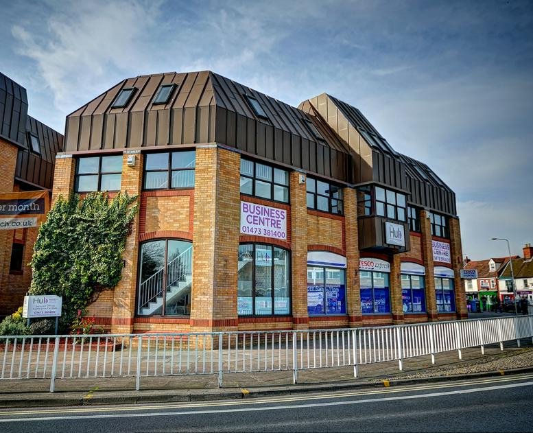 Exterior view of the brick-faced Hub Business Centre with brown mansard roof.