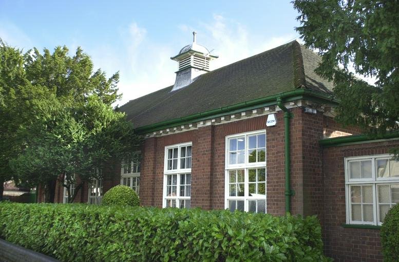 Exterior view of the brick facade and pitched roof at The Lawns, Hinckley, Leicestershire.
