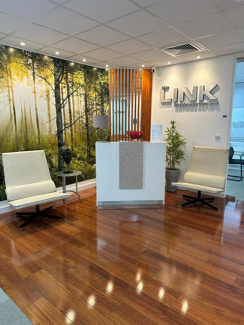 Reception area at The Link Business Centre, Thamesgate House featuring a forest mural and wood floors.