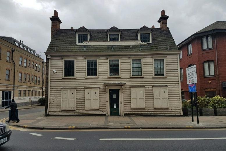 Exterior view of the historic wood-sided building of The Old Dispensary, 30 Romford Road, London.
