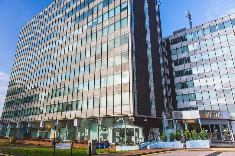 Exterior view of the multi-story glass and steel facade at The Vista Business Centre.