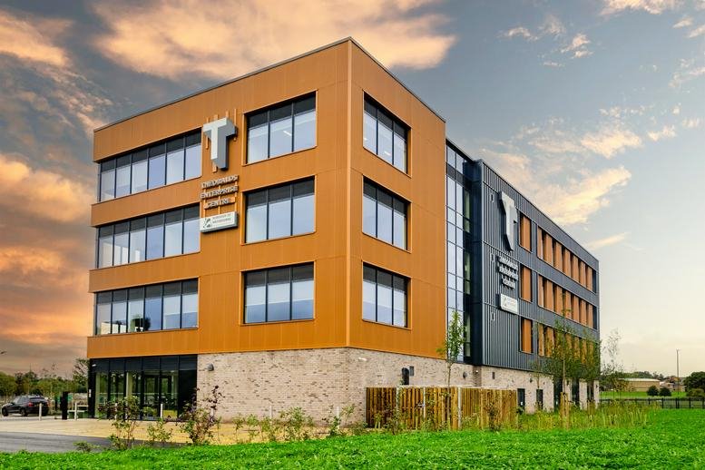 Modern four-story exterior of Theobalds Business Park, Innovation Place, featuring wood-paneling and large windows.