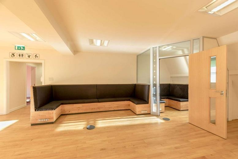 Spacious lounge area at Thorn House, 5 Rose Street, Edinburgh with natural wood finishes and built-in seating.