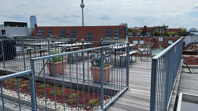 Spacious rooftop terrace at Torstraße 109, Rosenthaler Platz, Mitte, Berlin, Germany with a city skyline view.