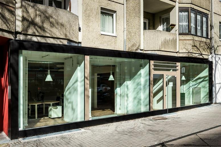 Street-level exterior view of the glass-fronted office building at Torstrasse 203.