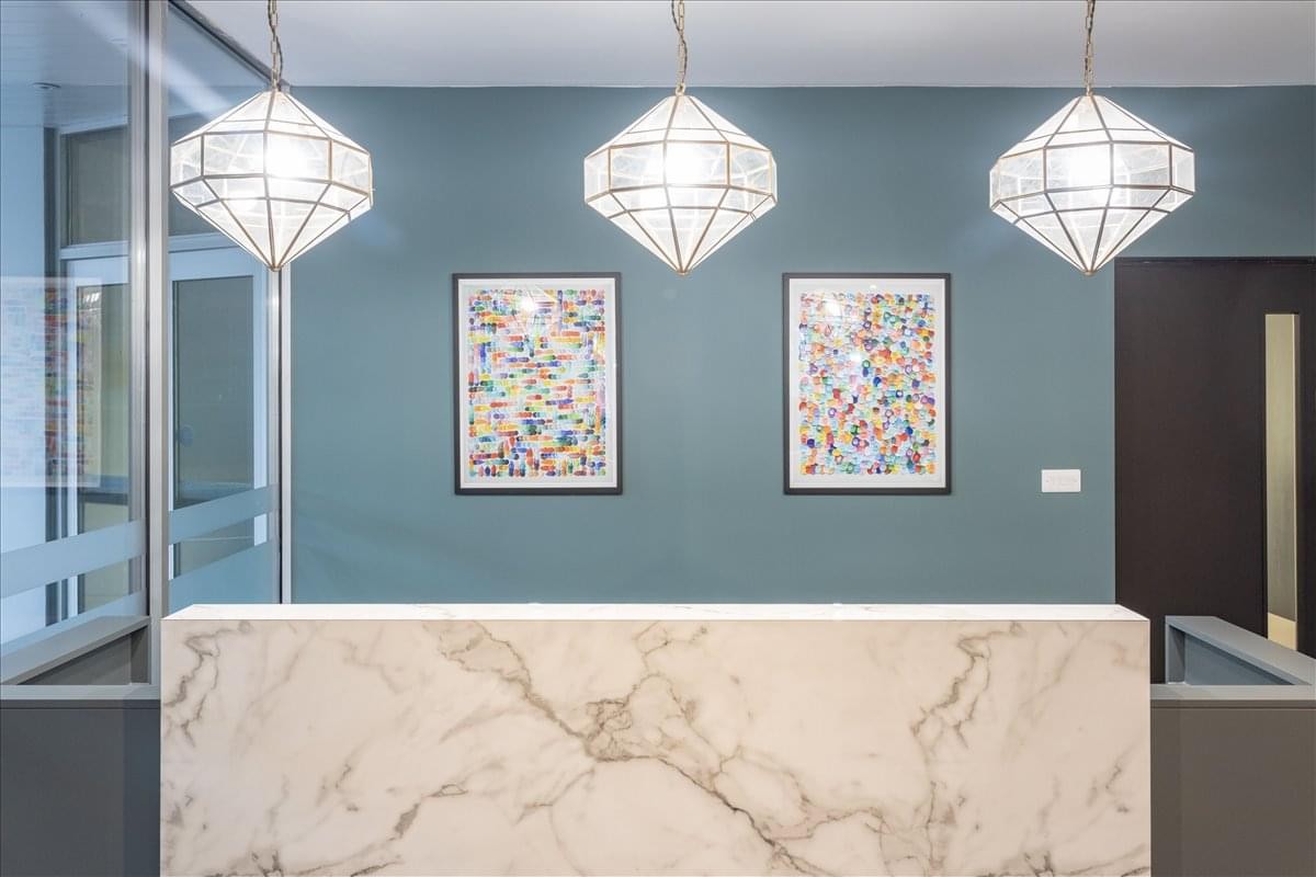 Reception area at Trafalgar House, 05 Fitzalan place with marble desk and designer pendant lights.