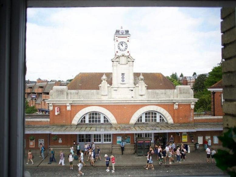 Exterior view of the historic brick and stone Tunbridge Wells, Kent station building with its prominent clock tower.
