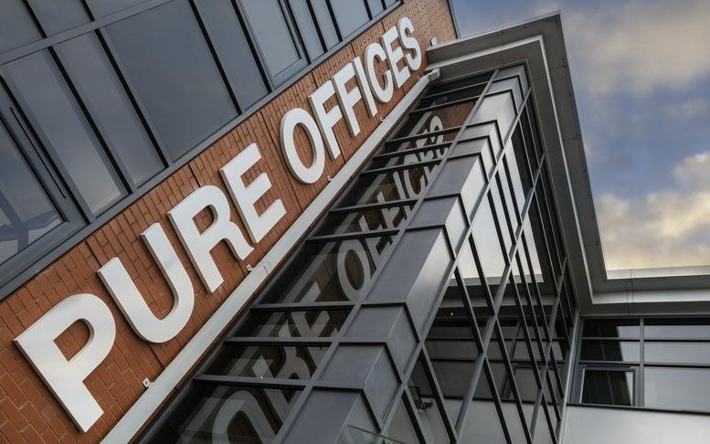 Exterior facade of Pure Offices at Turnberry Park Road showing modern brick and glass architecture.