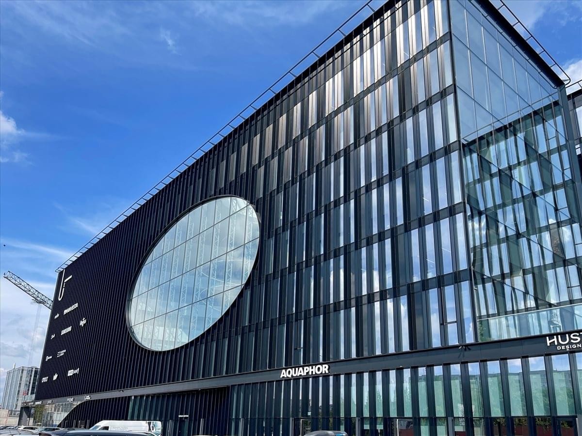 Exterior view of the sleek, glass-fronted building at Ukmergės Gatvė 219, Vilnius.