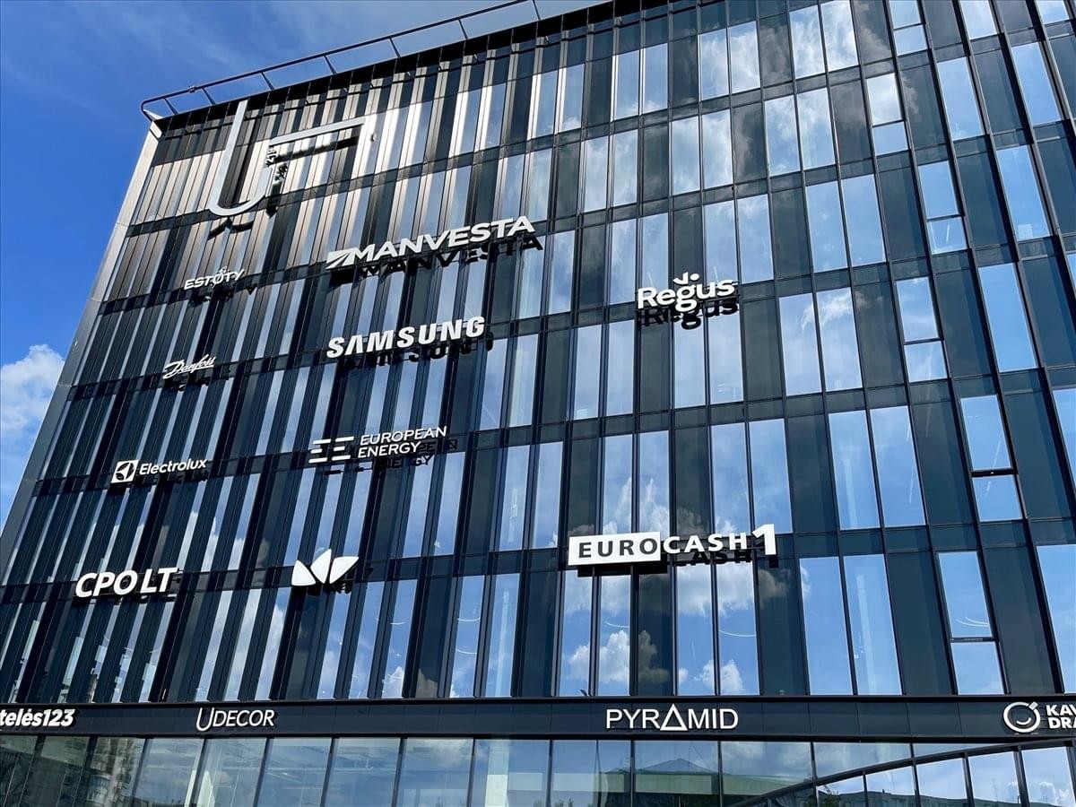 Exterior view of the modern glass-facade building at Ukmergės Gatvė 219, Vilnius.
