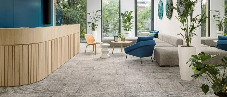 Spacious reception area with a curved wooden desk and lounge seating at MidPoint71.