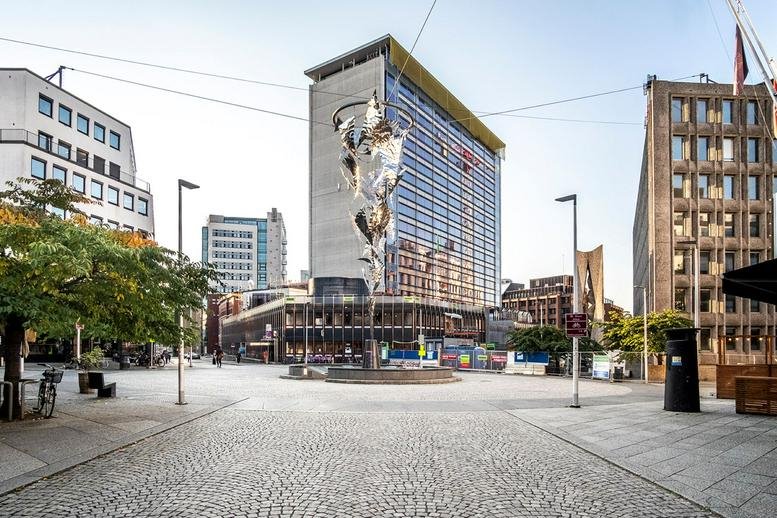 Exterior view of the modern glass and concrete building at Universitetsgaten 2, Oslo.