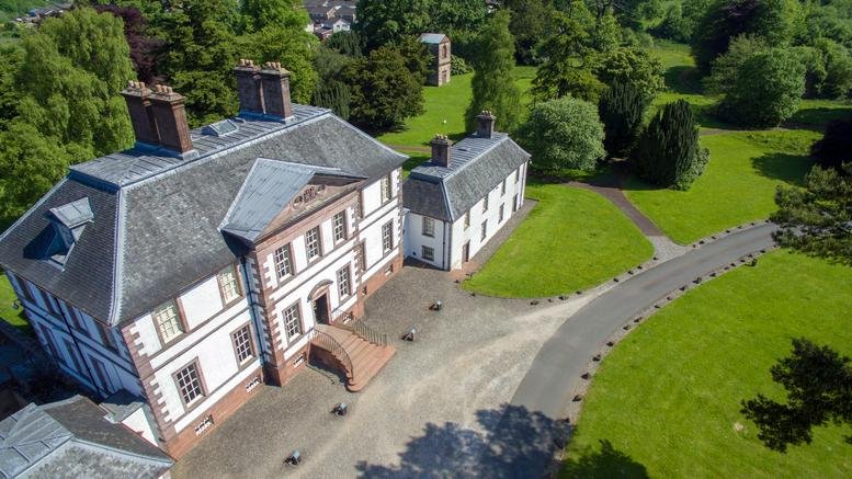 Aerial view of the historic Strathleven House with its white facade and multiple chimneys.