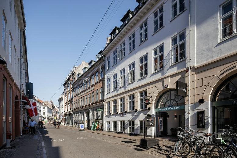 Exterior view of the historic white and stone building facade at Vestergade 29, Copenhagen.