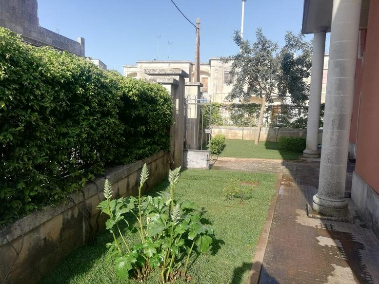 Exterior entrance and landscaped garden path at Via Castrignano, 23, Melpignano.