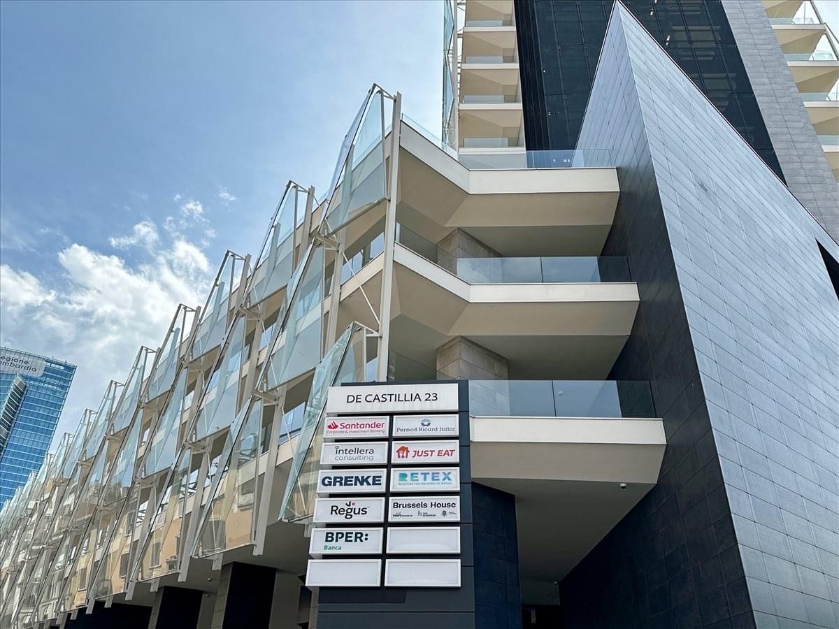 Exterior facade of the contemporary office building at Via Gaetano de Castillia, 23, Milan.