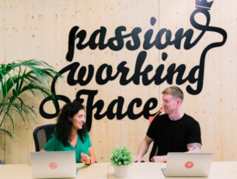 Lobby area at Via Giuseppe Giacosa 38 with a wooden feature wall reading passion working space.