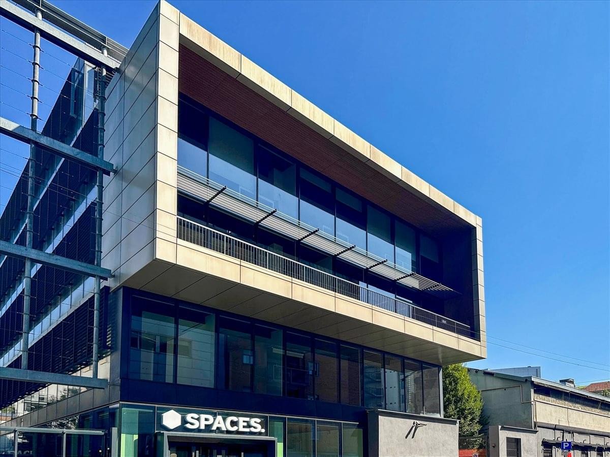 Exterior view of the modern glass and stone facade at Via Giuseppe Piazzi 2-4.