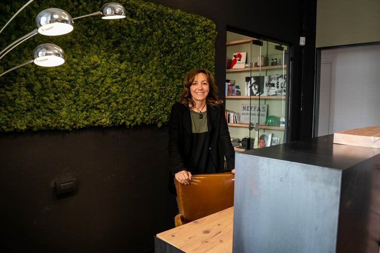 Reception area with a green wall and modern decor.