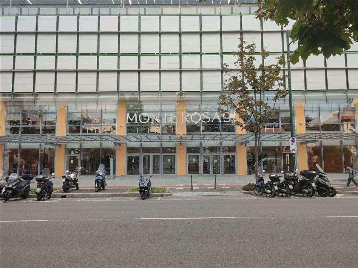 Exterior view of the glass-facade building at Via Monte Rosa, 91, Milan.