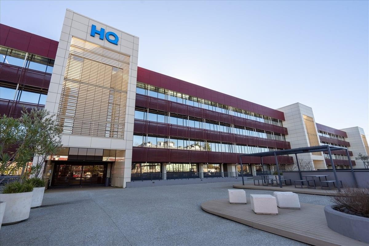 Modern exterior of Via Roma 108, Edificio CD1 with its distinctive red and glass facade.