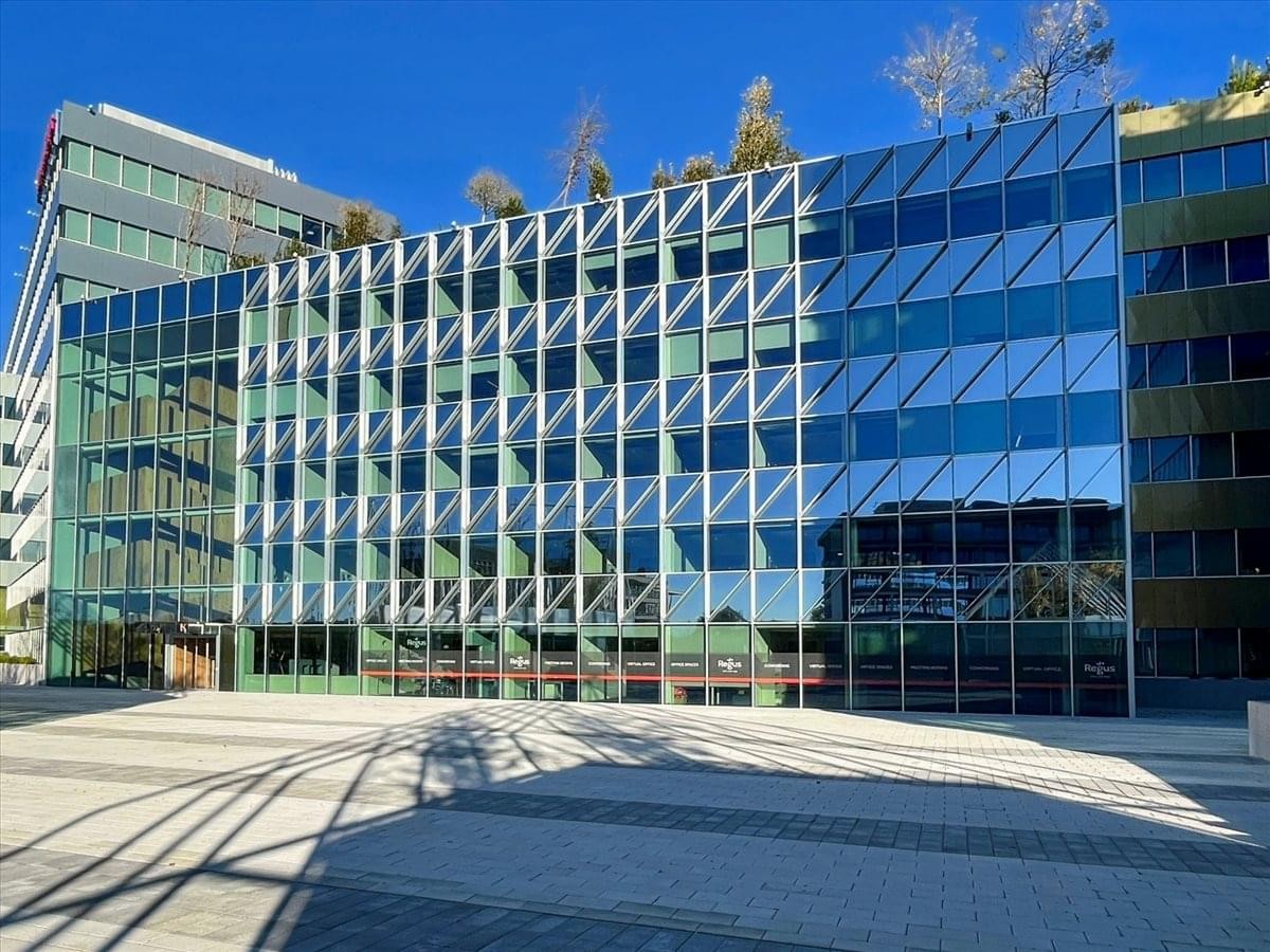 Exterior view of the modern glass-facade building at Via San Bovio, 3, Segrate.