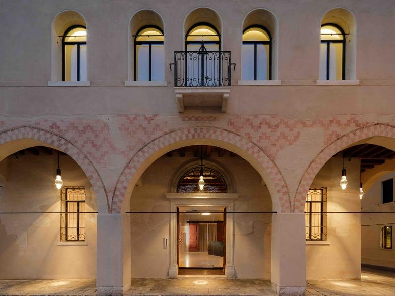 Exterior view of the historic arched facade at via San Nicolò, 42, Treviso.