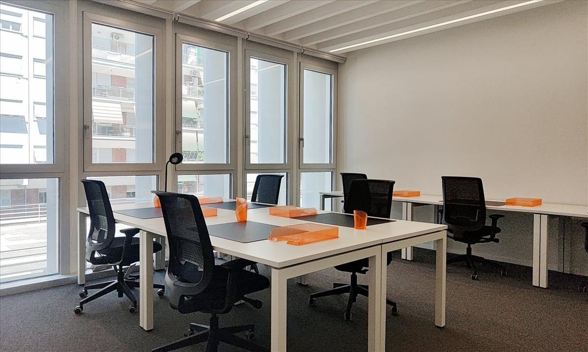 Exterior view of the office at Via Silvio D’Amico n. 40, Rome with flags outside.