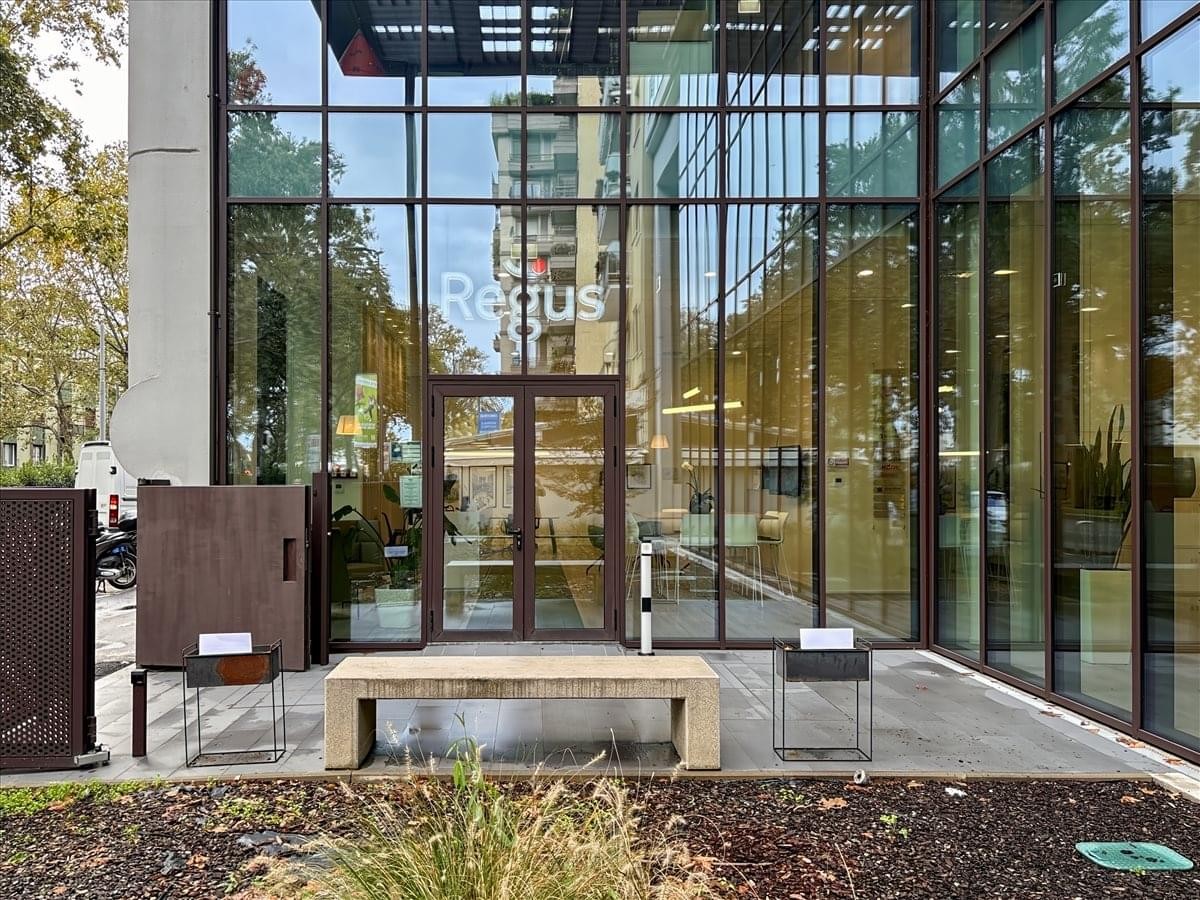 Main entrance of the glass-facade building at Viale Cassala n. 57, Milan.