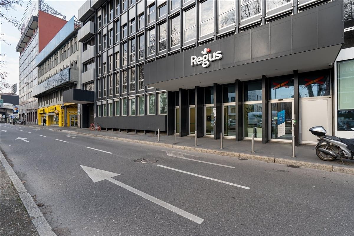 Street view showing the modern dark-facade exterior building at Viale Certosa 218, Milan.