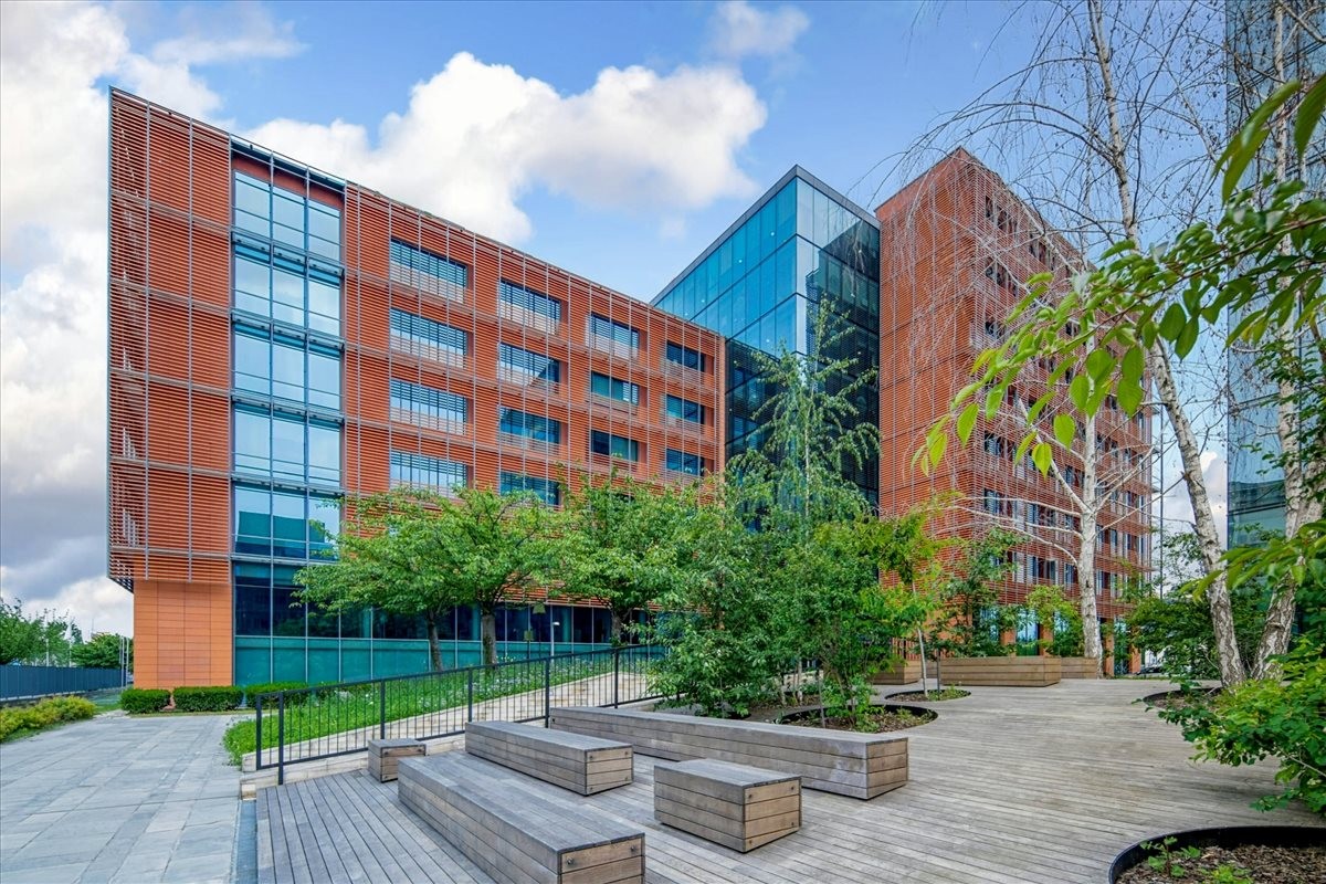 Exterior view of Viale Edison 110, Edificio “C” building with glass and brick facade.
