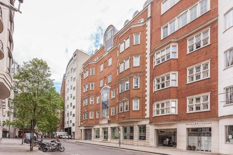 Exterior view of Nightingale House at 65 Curzon St with red brick facade and large bay windows.